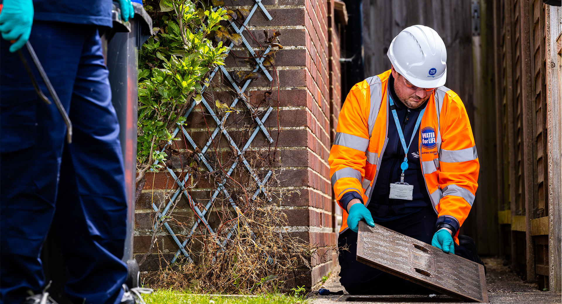 Southern water repair team putting on a drain cover
                        