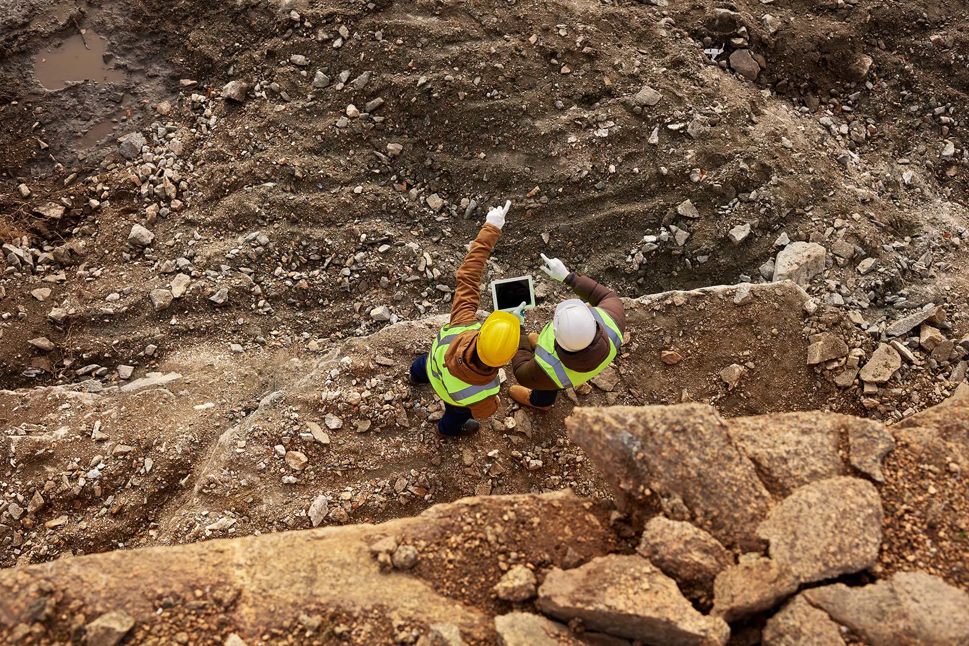 Two workers standing on a construction site