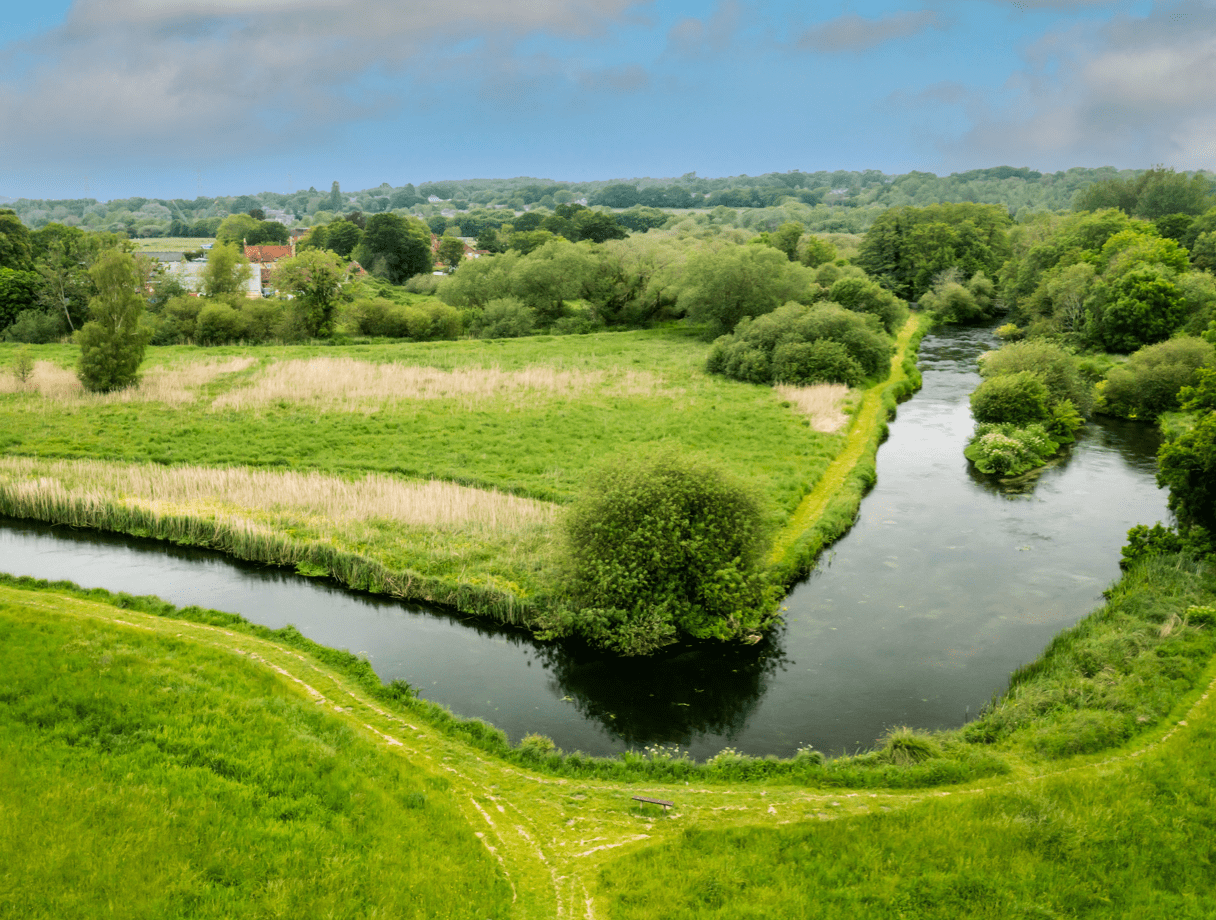 An aerial shot of a river meandering at ninety degrees