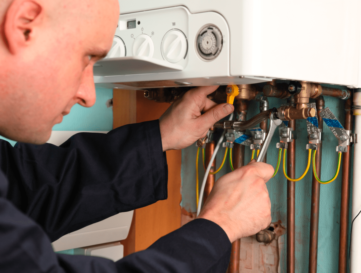 A worker on a home visit fixing pipes